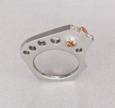 Unique modern design ring in sterling silver with two tube set topaz, one opposite each other through the ring. Diamonds and topaz set on the top of the ring. The ring fits comfortably against your pinky if worn on the ring finger and against the ring finger if worn on your pinky! Modern White Topaz Rings With Diamond Accents, Modern White Topaz Diamond Ring For Gift, Modern White Topaz Diamond Ring Gift, Modern Sapphire Ring With Diamond Accents As A Gift, Modern White Topaz Diamond Ring As Gift, Modern White Topaz Ring In White Gold, Modern White Gold Ring With White Topaz, Modern White Gold White Topaz Ring, Modern White Gold Open Birthstone Ring