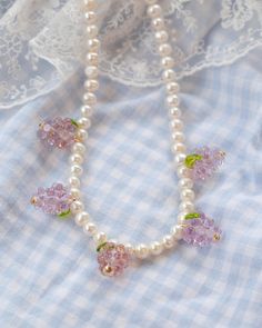 Introducing our Purple Grape Banquet necklace! Featuring our brand new Purple Grape charm! Every picnic blanket piece is lovingly designed and handcrafted completely in-house and perfectly finished in our jewellery studio. All of our pearly jewellery features only the highest quality iridescent freshwater pearls.  Every individual glass feature charm takes around half an hour to delicately form by hand in the flame, reaching temperatures of up to 800 degrees celsius, before heading to the kiln t Whimsical Handmade Pearl Jewelry, Whimsical Pearl Beaded Necklace, Whimsical Pearl Beaded Jewelry, Whimsical Beaded Pearl Jewelry, Handmade Purple Pearl Necklace For Gift, Handmade Purple Pearl Necklaces, Handmade Purple Pearl Necklace, Handmade Pearl Flower Necklace, Purple Grapes