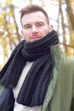 a man wearing a black scarf and jacket