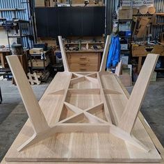 several wooden pieces of furniture in a workshop