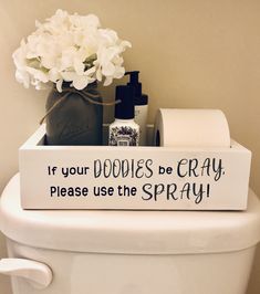 a toilet with a sign that says if your doodles be crazy please use the spray