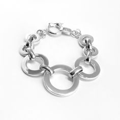 Classic round link bracelet in high polish, solid 950 Sterling silver. The largest link is centered. Makes a statement! Comes with a round safety latch clasp. Also available in Toggle clasp – please contact us if you wish for the latter.Bracelet length 8 inches.Gift boxed Luxury Classic Sterling Silver Bracelet With Round Cut, Luxury Link Jewelry With Stainless Steel Clasp, Luxury Jewelry With Stainless Steel Link Clasp, Luxury Modern Sterling Silver Round Bracelet, Luxury Sterling Silver Jewelry With Box Clasp, Luxury Modern Sterling Silver Bracelet With Solid Link, Luxury Sterling Silver Round Bracelet, Luxury Adjustable Sterling Silver Round Bracelet, Luxury Timeless Sterling Silver Round Bracelet