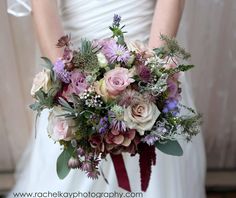 a bride holding a bouquet of flowers in her hands