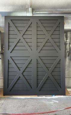 an image of a garage door that has been painted dark gray and is being worked on