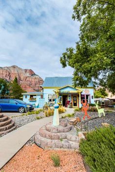 a blue building with colorful decorations in front of it and cars parked on the street