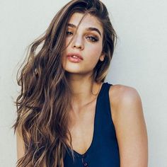 a beautiful young woman with long brown hair