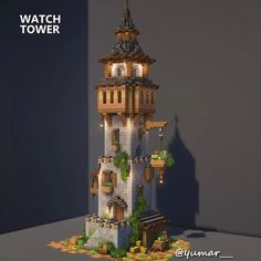 a tall tower made out of legos with plants growing on the top and below it