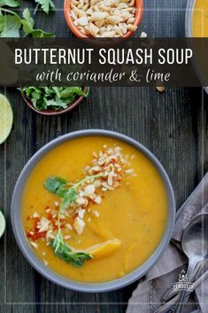 a bowl of butternut squash soup with coriander and lime on the side