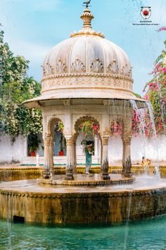 an ornate gazebo in the middle of a fountain