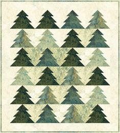 a quilt with many different trees on the front and back, all in shades of green