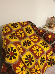 a crocheted blanket on a bed in a room