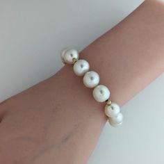 Introducing a top-notch White South Sea pearl bracelet, beautifully embellished with 14K yellow gold corrugated beads and fastened with a 14K yellow gold interlocking oval clasp. The pearls mesmerize with their 100% natural color – a radiant white with a soft whisper of pink overtone. The pearls are semi-baroque in shape. The high luster of the pearls is sure to captivate anyone's attention. With a length of 9.5" (24cm), this bracelet becomes a versatile accessory for any event, large or intimat Luxury Pearl Drop Bracelets With Round Beads, Luxury Bracelets With Pearl Drop And Round Beads, Luxury Pearl Drop Bracelets, Luxury Bracelets With Pearl Drop, Elegant Baroque Pearl Bracelet, Elegant Formal Baroque Pearl Bracelets, Elegant Formal Baroque Pearl Bracelet, Luxury Pearl Bracelet With Round Beads And Charm, White Baroque Pearl Bracelets For Formal Occasions