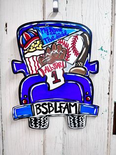 a sign on the side of a building that says bsplam and has baseballs painted on it