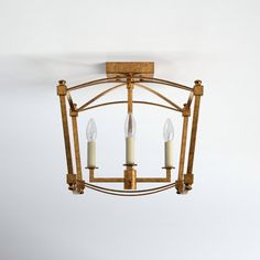 a chandelier with three candles hanging from it