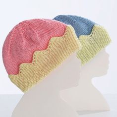 two knitted hats sitting on top of a white mannequin's head