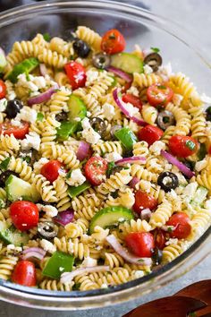 a bowl filled with pasta salad on top of a table