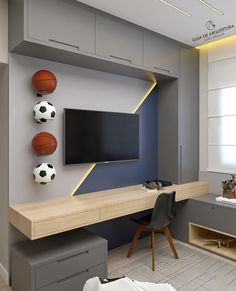 a sports themed living room with soccer balls on the wall