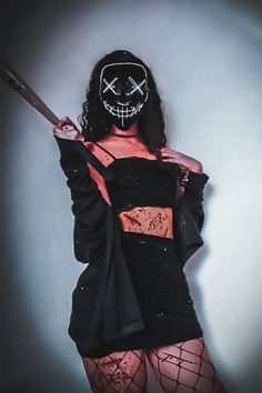 a woman wearing a mask and holding a knife