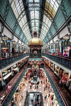 the inside of a shopping mall filled with people