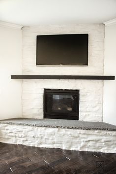 a flat screen tv mounted above a fireplace