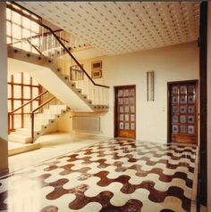 an empty room with tiled floors and stairs