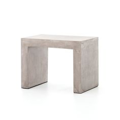 a small concrete table sitting on top of a white floor