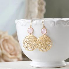 Blush Pink Glass and Gold Filigree Dangle Earrings. Pink Wedding Jewelry. Bridesmaid Earrings. These sweet earrings feature sparkly blush pink glass squares with beautifully textured filigree pendants dangling below. The pink glass stones can be changed to a different color upon your request. ♥Measurement and details: Total length: approx. 1.8" (47mm) Pink glass stone: 8mm Ear Wires: gold plated over brass, High quality plated. Anti tarnish ♥ More beautiful modern earrings are available here: ww Rose Gold Filigree Wedding Jewelry, Rose Gold Filigree Jewelry For Wedding, Elegant Pink Round Chandelier Earrings, Delicate Gold Earrings For Bridal Shower, Ornate Chandelier Earrings For Wedding, Pink Chandelier Earrings For Wedding, Pink Round Chandelier Earrings For Wedding, Wedding Earrings With Intricate Design, Elegant Gold Earrings For Bridesmaids