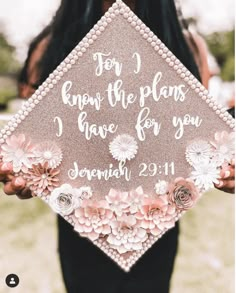 a woman holding up a graduation cap that says for i know the plans i have for you