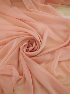 the fabric is soft and light pink in color, but it doesn't look like silk