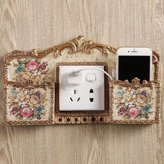 an iphone is plugged into the outlet in this ornately decorated wall charger