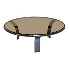 a round glass table with metal legs and a circular glass top, on an isolated white background