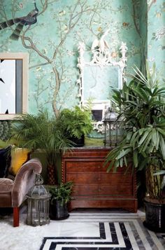 a living room filled with furniture and lots of green plants in front of a mirror