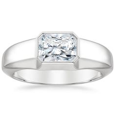 a white gold ring with a princess cut diamond in the center, on a white background