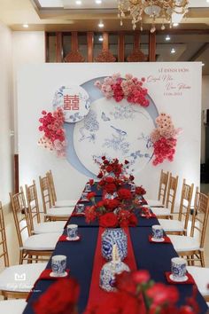 the table is set with red and blue flowers