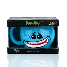 a blue coffee mug in a black box with an evil face on it's side