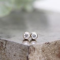 "This pair of tiny 14k white gold stud earrings feature small white diamonds. These earrings are small enough to wear every day. This unisex luxury gift is ready to ship. Two tiny white gold stud earrings with sparkling, round faceted 3mm white diamonds. These are the perfect every day earrings for a single or second piercing with just the right amount of flash. This listing is for two earrings. Diamonds: 3mm, .10 carat each, .20 total carat weight, SI1, G-H. Solid 14k white gold with 14k white Earrings Diamonds, White Gold Stud Earrings, Second Piercing, Gold Diamond Studs, Sapphire Earrings Studs, White Gold Earrings Studs, White Gold Studs, Diamond Alternatives, Unisex Gift