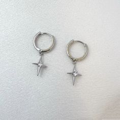 Elevate your streetwear game with our Star Dangle Drop Earrings! Exuding punk and hip hop vibes, these earrings are perfect for men and women alike. Stand out from the crowd and add a touch of edgy style to your look. Perfect for expressing your unique personality. Earrings length 1.0 inch width 0.3 inch. Streetwear Dangle Pierced Earrings, Streetwear Dangle Earrings, Trendy Metal Earrings For Streetwear, Single Metal Earring For Streetwear, Trendy Metal Hoop Earrings For Streetwear, Silver Trendy Hoop Earrings For Streetwear, Punk Dangle Earrings For Streetwear, Metal Hoop Earrings For Streetwear, Punk Style Pierced Earrings For Streetwear