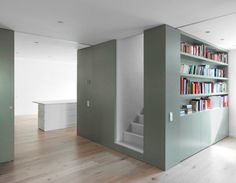 an empty room with bookshelves and stairs