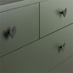 two heart shaped knobs on the drawers of a dresser