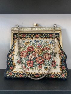 In the shop this week we have in a 1950's Floral Embroidered Hand Bag!  It's virtually never been used and is in great condition!  This would make a good piece for a night out paired with a long black dress!  The gold enamel really makes this piece pop!  Would love for this to go to a good home! Vintage Embroidered Evening Bag For Party, Vintage Embroidered Formal Bags, Vintage Embroidered Evening Bags, Gold Vintage Embroidered Evening Bag, Vintage Evening Bag With Gold-tone Hardware, Vintage Evening Bags, Long Black Dress, Gold Enamel, Vintage 1950s