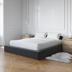 a bed sitting on top of a wooden floor