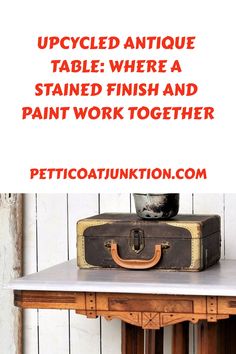 an old suitcase sitting on top of a table with the words, upcycled antique table where a stained finish and paint work together