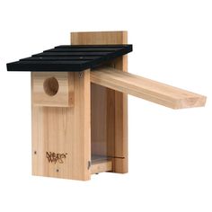 a wooden bird house with a black roof