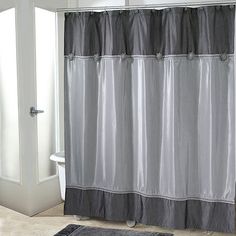 a bathroom with a black and white shower curtain