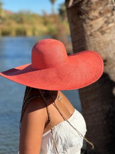 Gorgeous burn salmon color sun hat in an 8" wide brim. Hand woven in a brisa weave with a round dome crown. Available in medium and large. Our hats are handwoven with extreme attention to detail and dedication to traditional techniques. Each Paja Toquilla hat is a testament to the slow fashion movement, honoring the skill and artistry of our artisans who have faithfully preserved their craft for generations.  OUR HAND CRAFTED HATS PROCESS Paja toquilla, is a palm-like plant which is used to weave our hats and can be found off the coast of ecuador.  the soft middle palm leaves are washed and placed out in the sun to dry. the sun bleaches the straw, making it strong and flexible for easy weaving.  weaving is a unique skill, depending on the fineness of the weave, a single hat can take up to Lightweight Flat Brim Straw Hat For Sunbathing, Pink Wide Brim Boater Hat For Vacation, Pink Straw Hat For Beach And Kentucky Derby, Pink Straw Hat For Kentucky Derby And Beach, Pink Straw Hat For Kentucky Derby Beach Outing, Pink Flat Brim Boater Hat For Beach, Chic Pink Wide Brim Straw Hat, Wide Brim Pool Hat, Pink Wide Brim Boater Hat For Beach