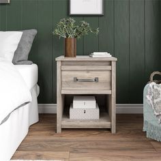 a bedside table with two drawers and a blanket on the floor in front of it