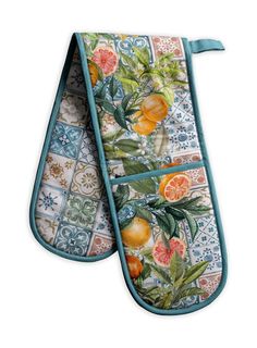 two oven mitts with oranges and leaves on them, one has an oven mitt