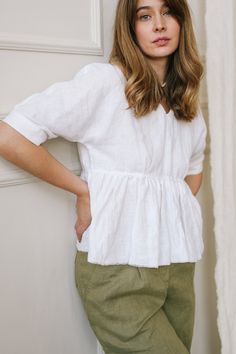 "Ruffled Linen Top is destined to cheer you up. The Peplum Top is designed in a relaxed fit complemented with a breezy raw hem and looks really airy and delicate. Being an easy fit, this white linen blouse is ideal for summer, matching the weather and the vibes. The plunging V-neck accentuates the area slimming your neck and makes it seem longer. This blouse will be a trusty attire in your wardrobe, which you can combine with various pants and shorts. DETAILS ⚬ Raw hem. ⚬ Decorated with handmade Feminine Relaxed Fit Peasant Top For Daywear, Chic Flowy Linen Tops, Relaxed Fit Short Sleeve Blouse For Brunch, Spring Linen Top For Brunch, Spring Breezy Relaxed Fit Blouse, Linen V-neck Tops With Ruffles, White Spring Blouse For Casual Gatherings, Flowy Short Sleeve Breezy Top, Relaxed Fit V-neck Ruffle Blouse