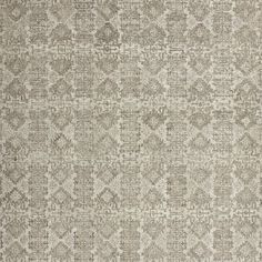 an area rug with many different patterns on the ground, including one in grey and white