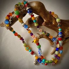 This cheerful long floral stretchy necklace features 86 glass beads, most of them millefiori, and some small gemstones like, turquoise, jade, agate, cat's eye, howlite, serpentine, 52 silver tone bead dividers and 8 charms, including a lady bug silver charm.  It is 28 inches long and weights  2.5oz. Millefiori  ( Italian) is a glasswork technique which produces distinctive decorative patterns on glassware.  The term millefiori is a combination of the Italian words "mille' (thousand) and "fiori" (flowers). The colorful beads can brighter your day and cheer you all day long for they radiate a positive and joyful feeling.  You can wear it as a necklace or you can convert it in a multi strand bracelet. This can make a great gift for mother, daughter, sister, bride's maid, Anniversary, birthday Adjustable Multicolor Crystal Necklace With Large Beads, Multicolor Single Strand Crystal Necklace For Healing, Adjustable Multicolor Crystal Necklaces With Large Beads, Spiritual Multicolor Single Strand Crystal Necklace, Bohemian Multicolor Round Beads Long Necklace, Bohemian Multicolor Beaded Long Necklace, Bohemian Multicolor Czech Glass Beaded Necklaces, Hippie Multicolor Gemstone Bead Necklaces, Hippie Multicolor Gemstone Beads Necklace